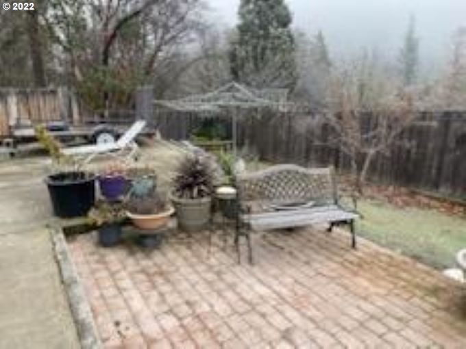 793 Jumpoff Joe Creek Road Grants Pass, OR 97526 - Photo 12 of 12 a backyard of a house with fountain table and chairs