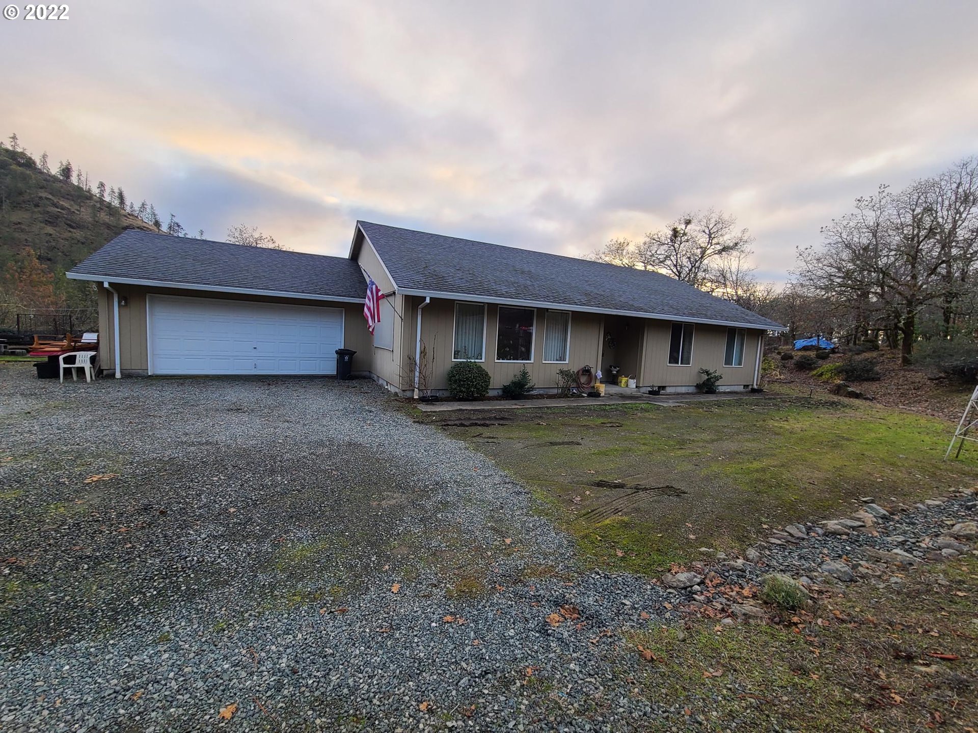793 Jumpoff Joe Creek Road Grants Pass, OR 97526 - Photo 2 of 12 a front view of a house with garden