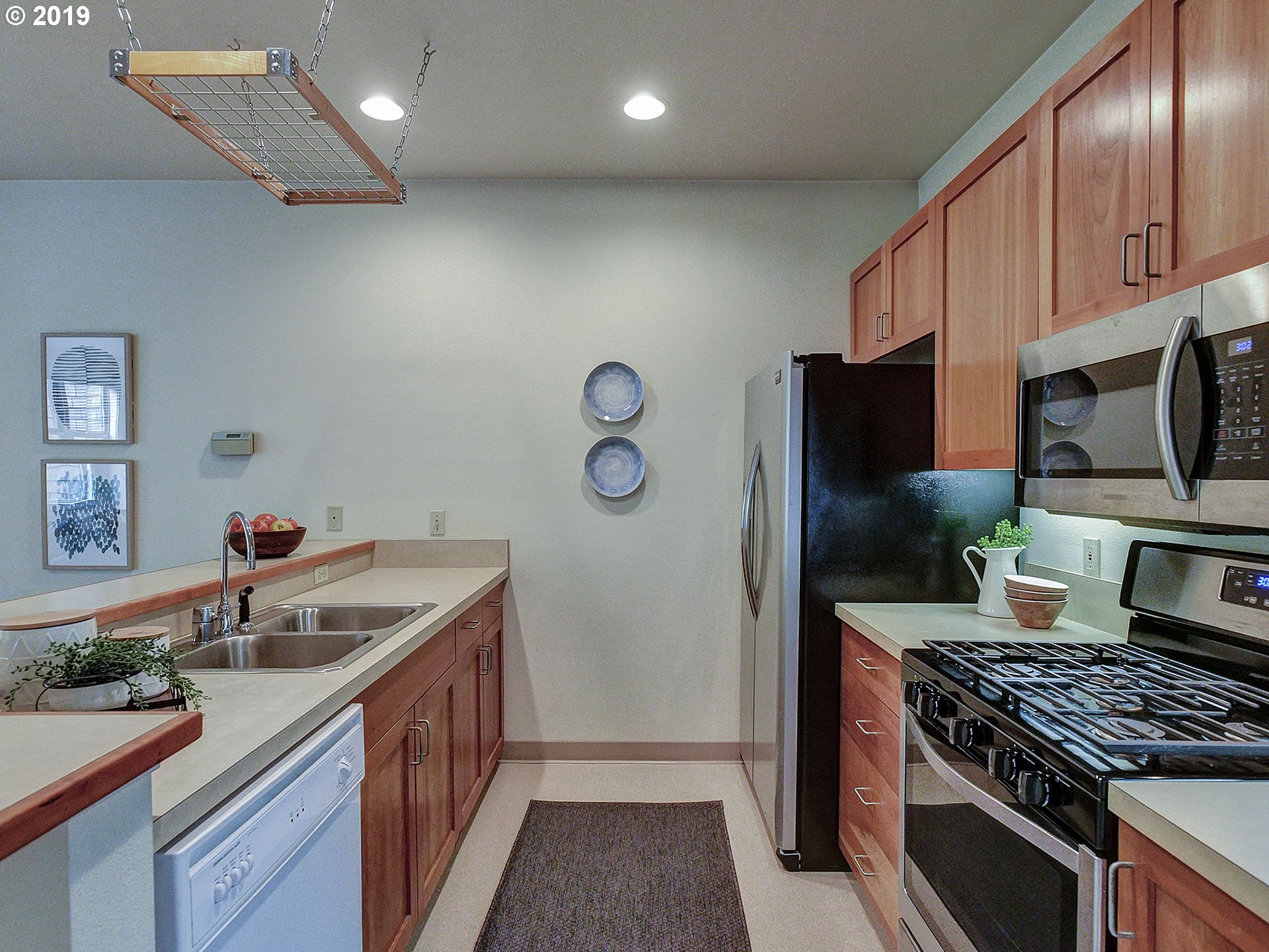 715 Southeast 34th Avenue Portland, OR 97214 - Photo 11 of 24 a kitchen with stainless steel appliances granite countertop a sink stove and refrigerator