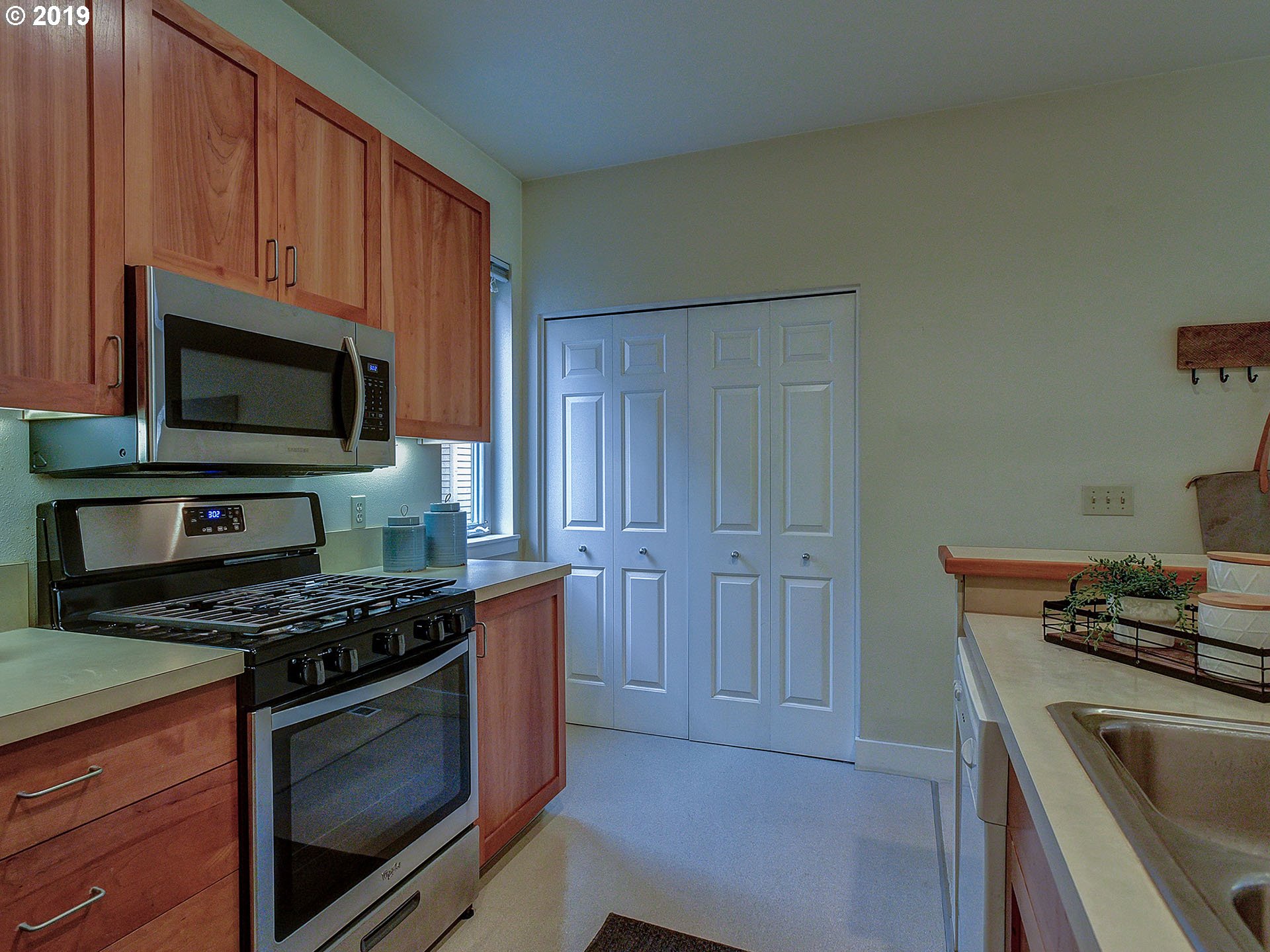 715 Southeast 34th Avenue Portland, OR 97214 - Photo 13 of 24 a kitchen with wooden cabinets and stainless steel appliances