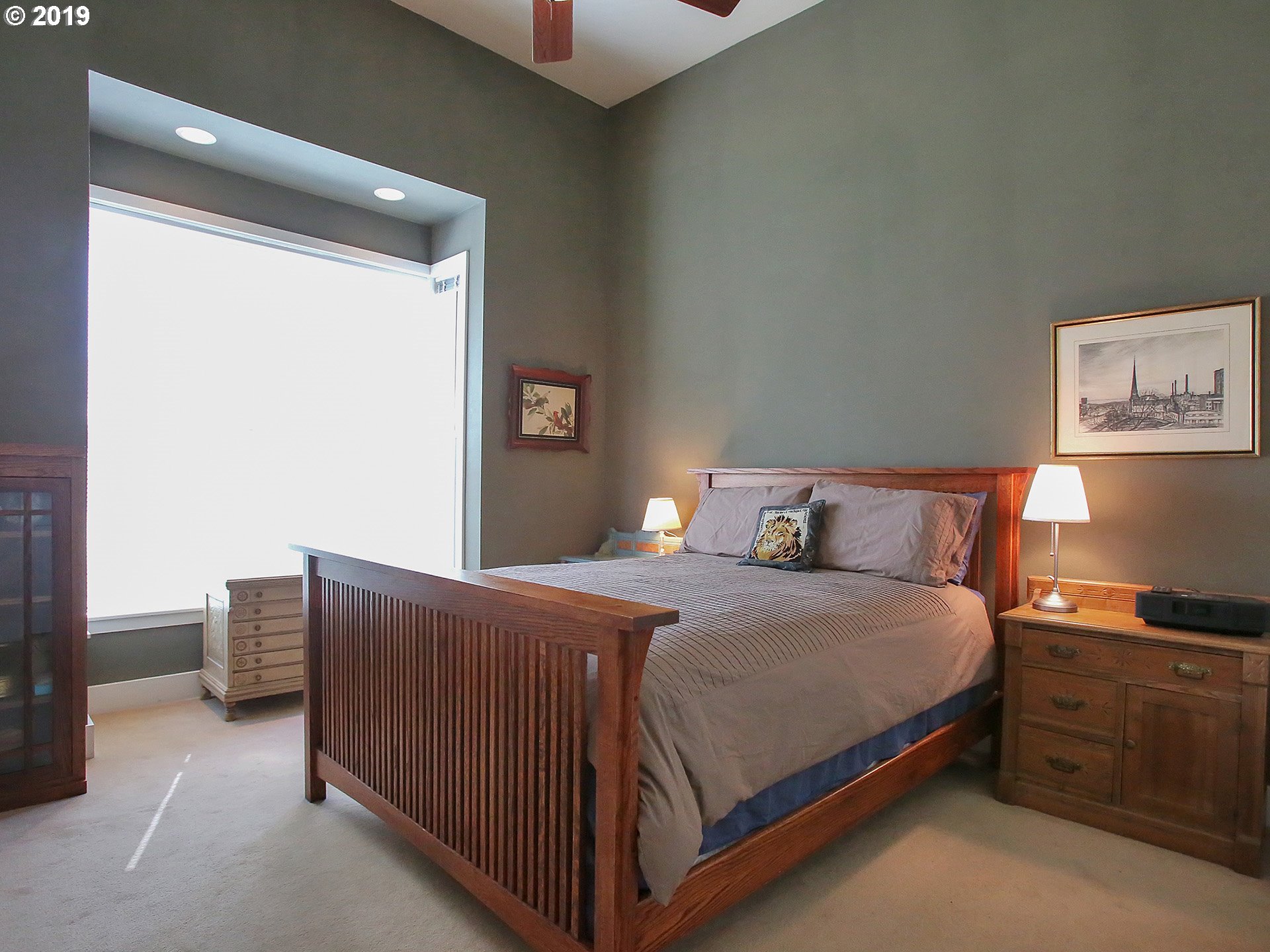 715 Southeast 34th Avenue Portland, OR 97214 - Photo 15 of 24 a bedroom with bed cabinet and window