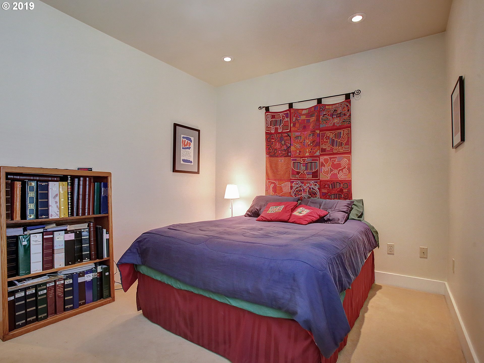 715 Southeast 34th Avenue Portland, OR 97214 - Photo 18 of 24 a bedroom with a bed and a book shelf
