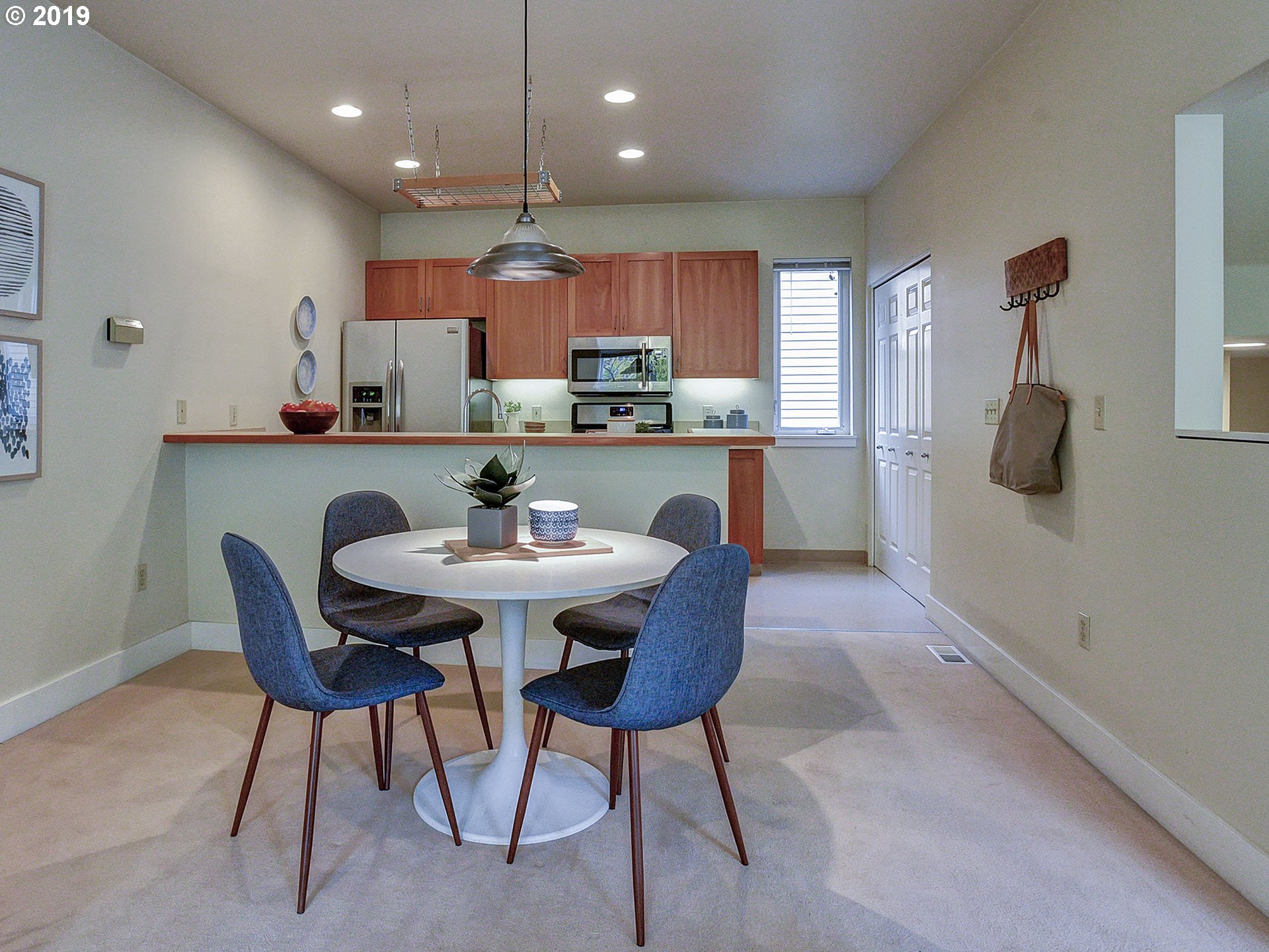 715 Southeast 34th Avenue Portland, OR 97214 - Photo 9 of 24 a kitchen with a table chairs stove and microwave