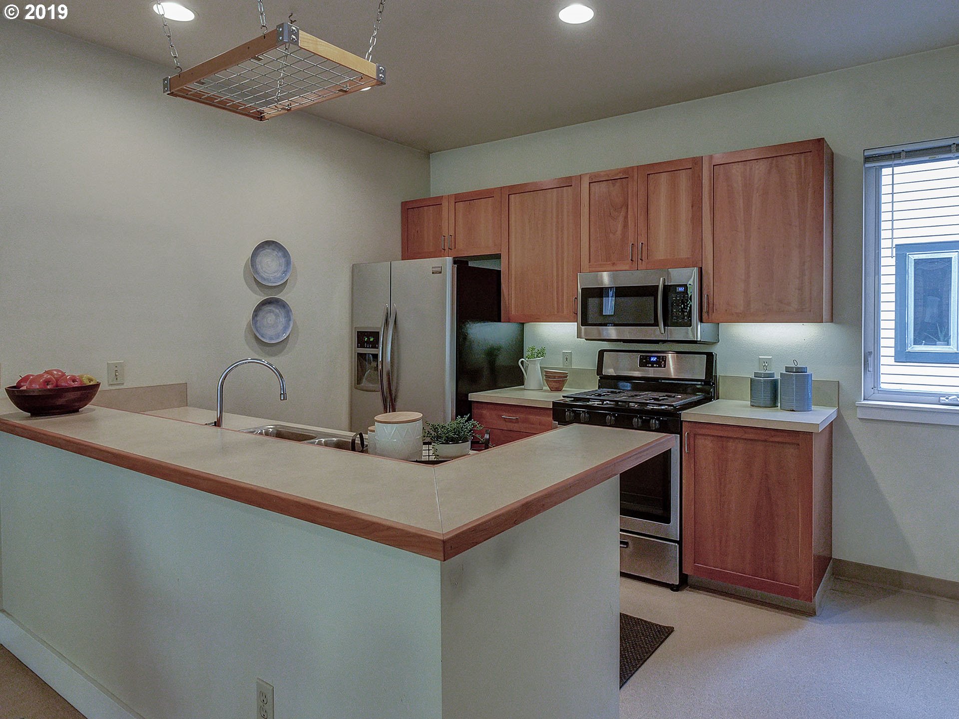 715 Southeast 34th Avenue Portland, OR 97214 - Photo 10 of 24 a kitchen with kitchen island a sink appliances and cabinets