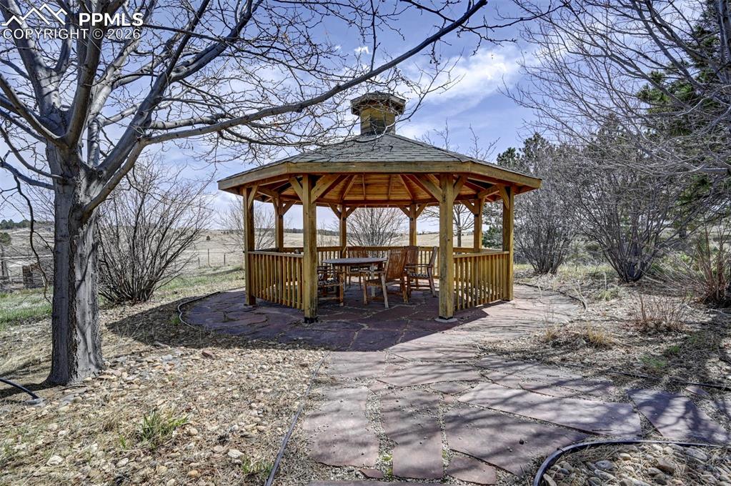5910 McCart Ranch Circle Elizabeth, CO 80107 - Photo 29 of 50 a view of a patio with a table and chairs under an umbrella