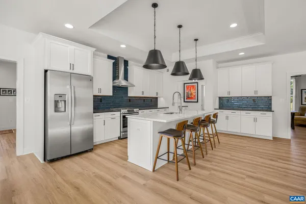 a large kitchen with a table and chairs