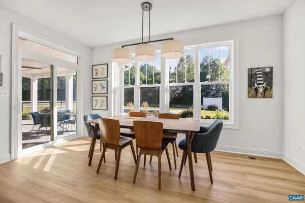 a kitchen with stainless steel appliances granite countertop a stove and a wooden floors