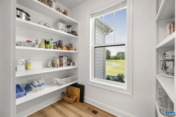 a bathroom with a granite countertop toilet sink and mirror