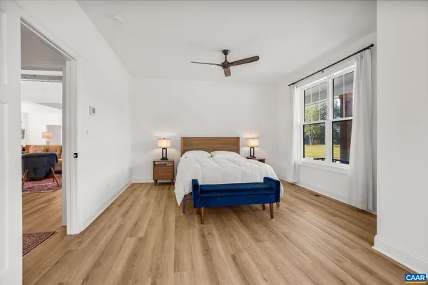 a spacious bathroom with a granite countertop sink mirror and toilet