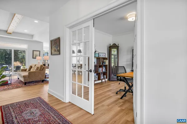a kitchen with stainless steel appliances granite countertop a dining table chairs and sink