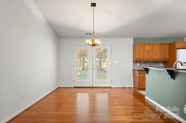 a view of a kitchen with a refrigerator and a window