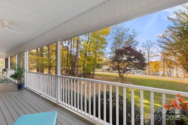 a living room with furniture and floor to ceiling windows