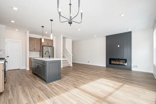 a large white kitchen with wooden floor