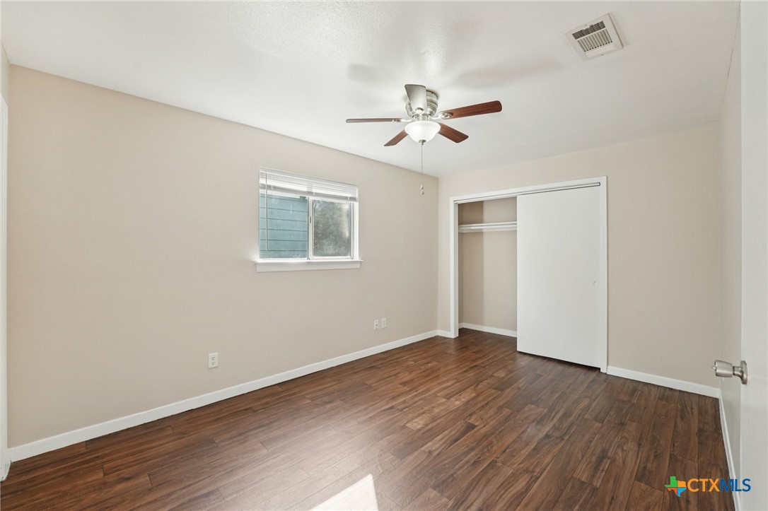1634 Post Road, Unit 4 San Marcos, TX 78666 - Photo 7 of 11 a view of empty room with wooden floor and fan