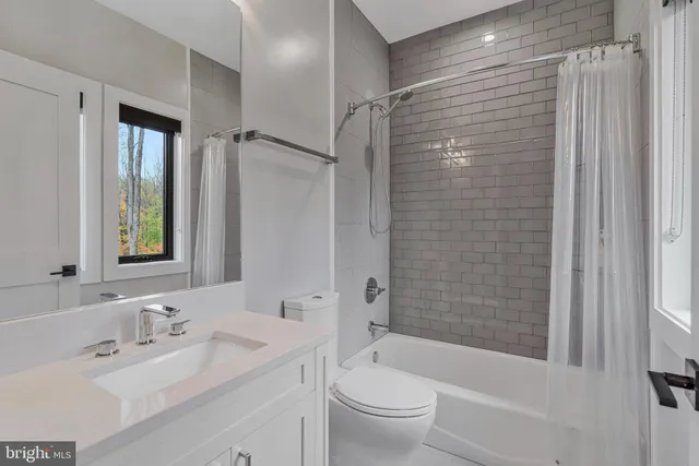 a bedroom with a large bed and a couch