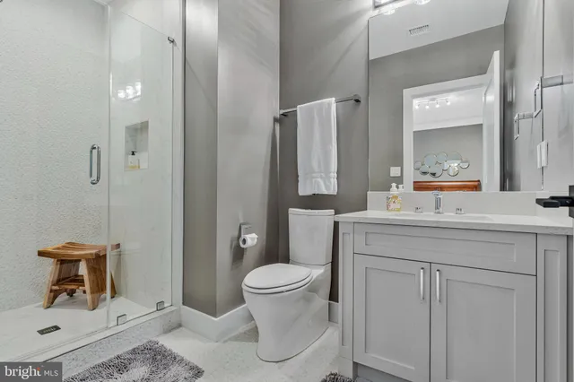 a bathroom with a shower a toilet and a shower