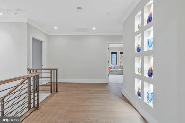a view of a living room and kitchen with furniture wooden floor and a chandelier