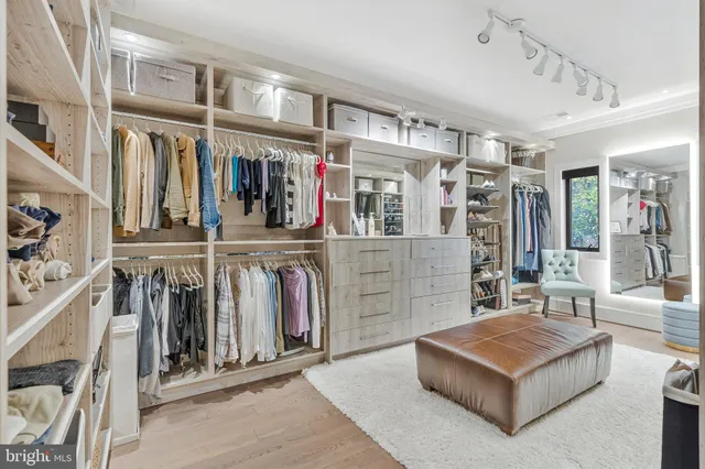 a view of a dining room with furniture a chandelier and wooden floor