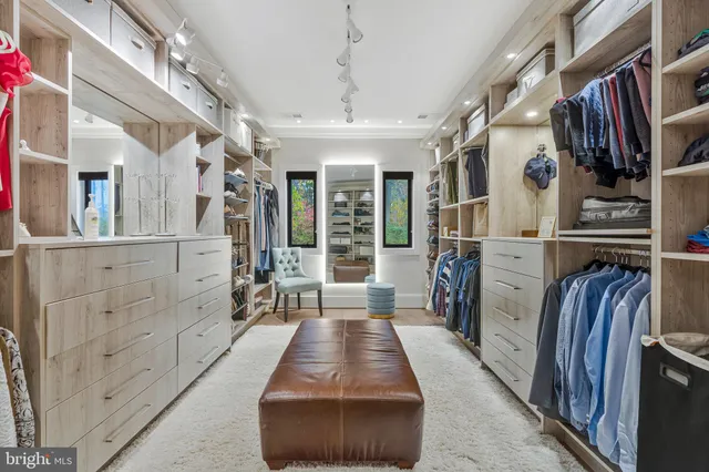 a dining room with furniture a chandelier and wooden floor