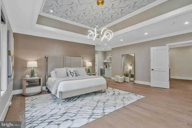 a living room with couches a coffee table and a large window with wooden floor