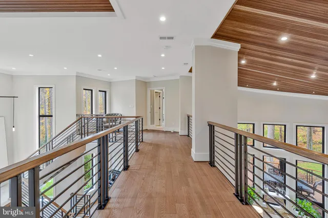 a living room with furniture and large windows