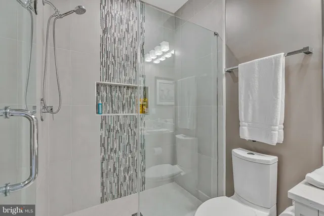 a living room with furniture a table and kitchen view