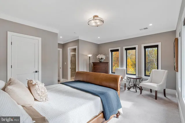 a living room with furniture a large window and a fireplace