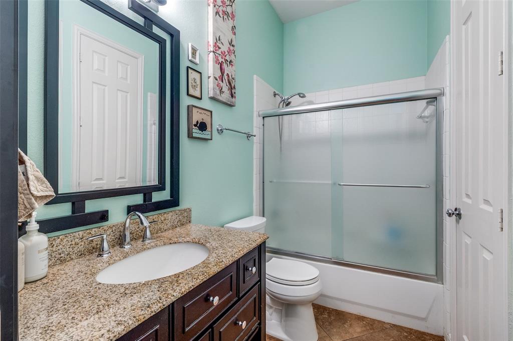 1802 Benedict Court Rowlett, TX 75088 - Photo 12 of 30 a bathroom with a granite countertop sink toilet and shower