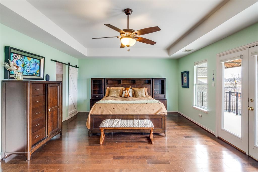 1802 Benedict Court Rowlett, TX 75088 - Photo 15 of 30 a bedroom with a bed and wooden floor