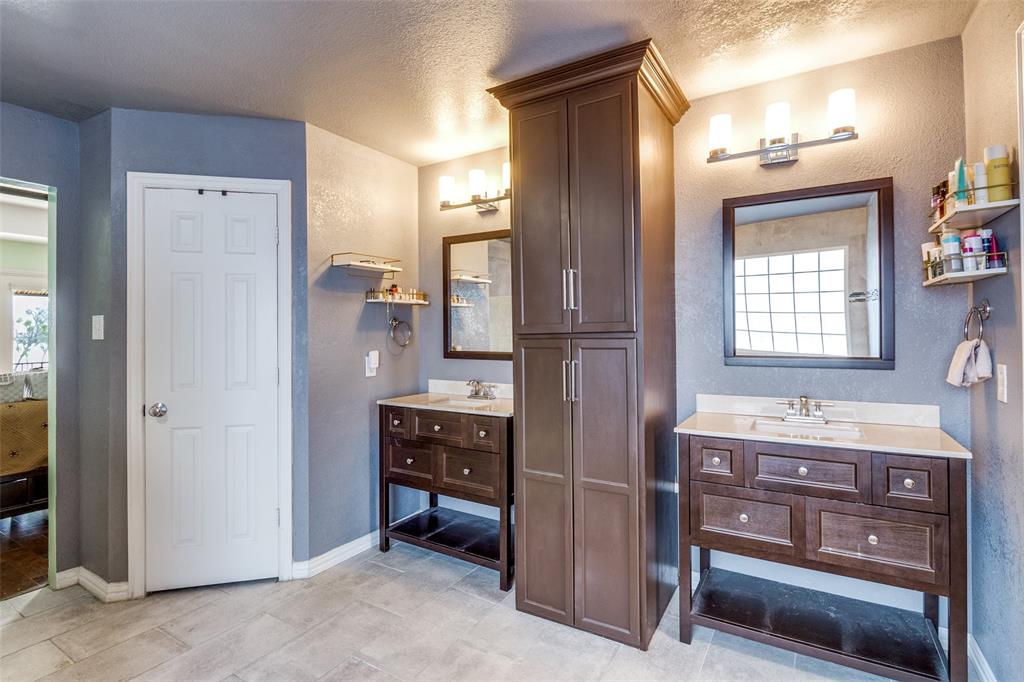 1802 Benedict Court Rowlett, TX 75088 - Photo 16 of 30 a bathroom with a double vanity sink a mirror and a shower