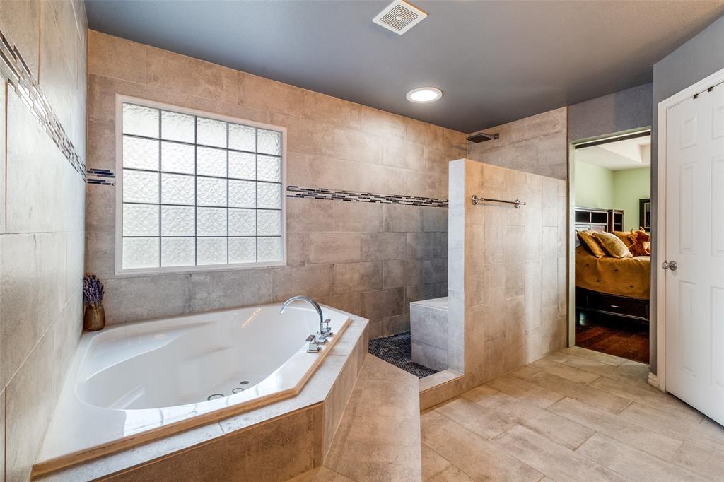 1802 Benedict Court Rowlett, TX 75088 - Photo 17 of 30 a bathroom with a bathtub and a shower