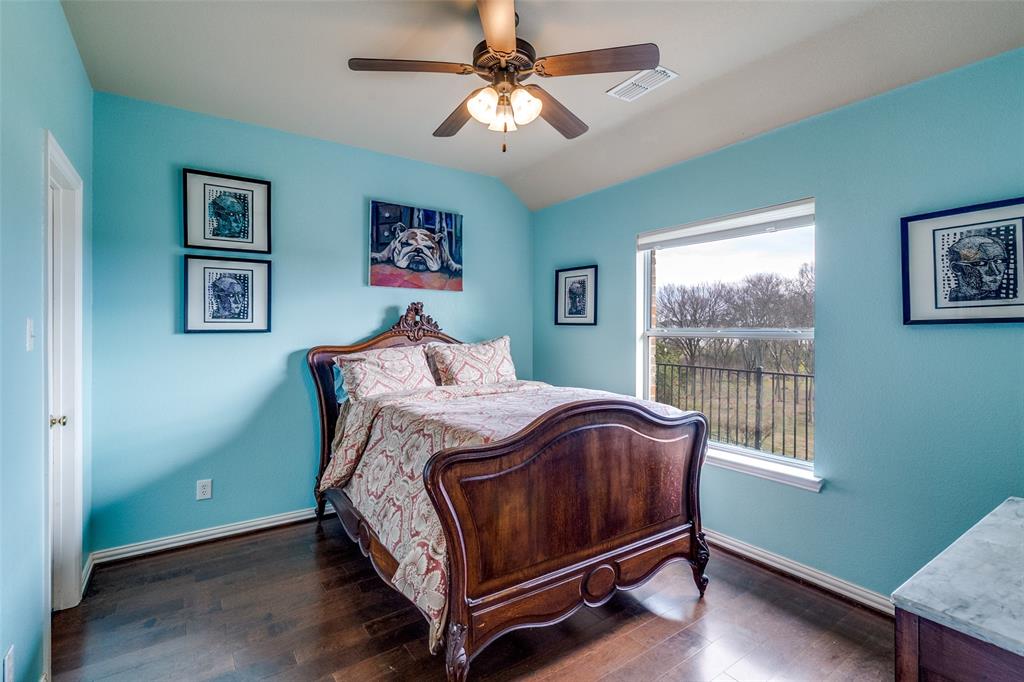 1802 Benedict Court Rowlett, TX 75088 - Photo 20 of 30 a bed sitting in a bedroom next to a window