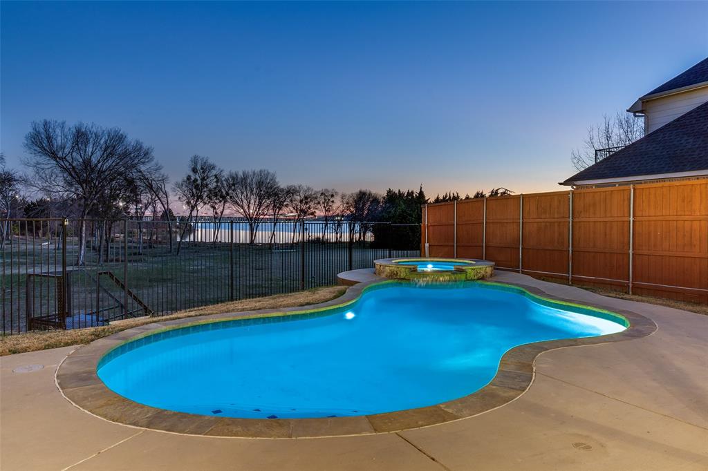 1802 Benedict Court Rowlett, TX 75088 - Photo 2 of 30 a view of a swimming pool with a yard and wooden fence