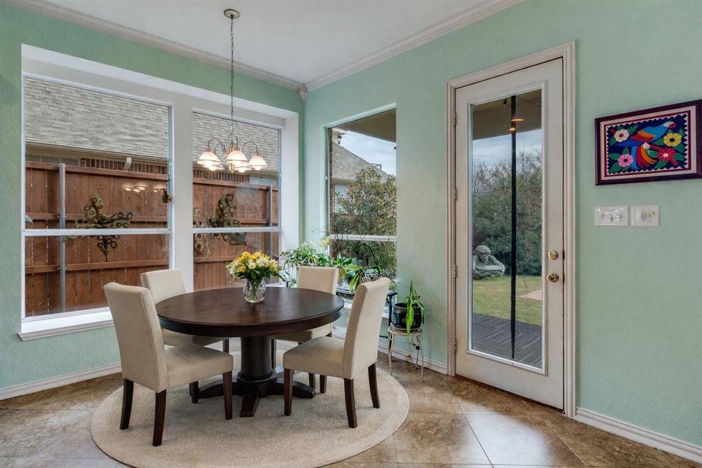 1802 Benedict Court Rowlett, TX 75088 - Photo 10 of 30 a dining room with furniture large windows and a chandelier