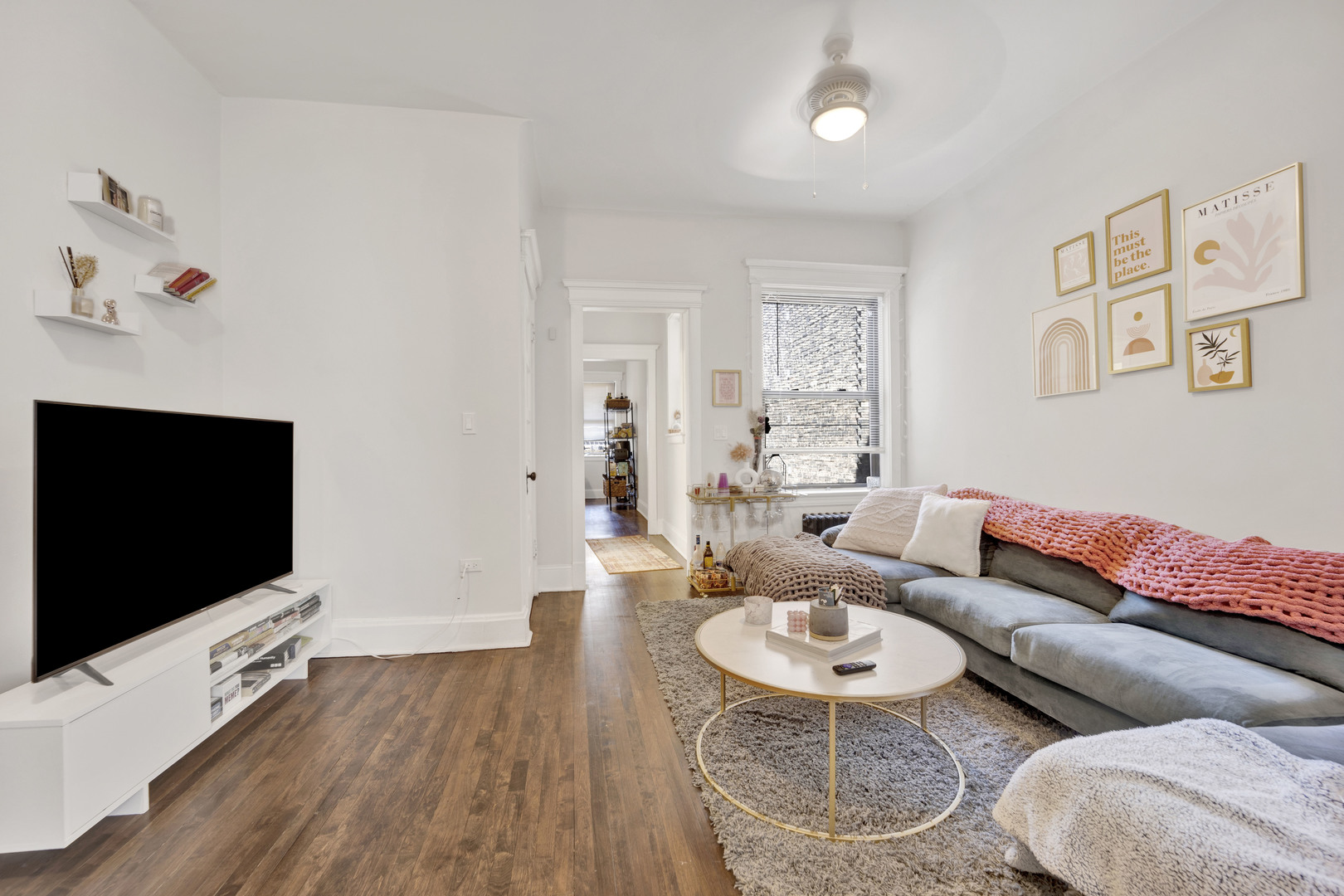 3934 North Sheridan Road, Unit 3 Chicago, IL 60613 - Photo 2 of 12 a living room with furniture and a flat screen tv