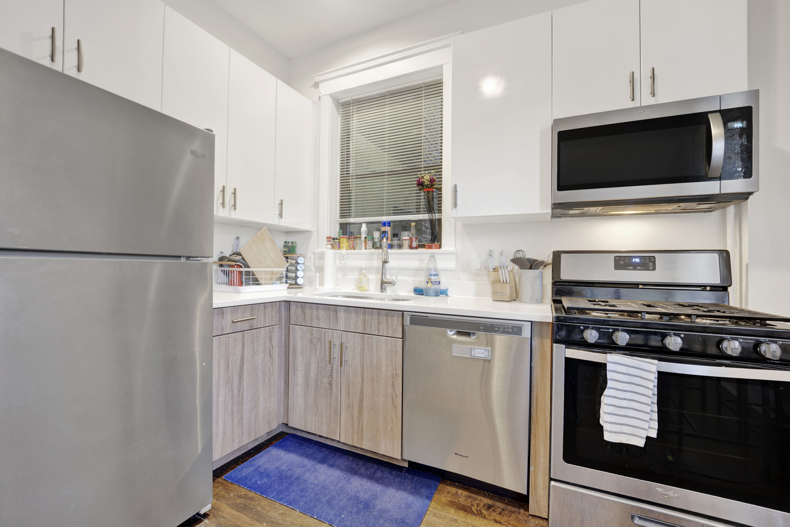 3934 North Sheridan Road, Unit 3 Chicago, IL 60613 - Photo 3 of 12 a kitchen with a refrigerator stove and microwave