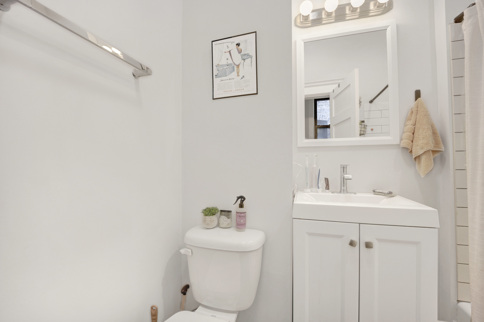 3934 North Sheridan Road, Unit 3 Chicago, IL 60613 - Photo 7 of 12 a bathroom with a toilet sink and mirror