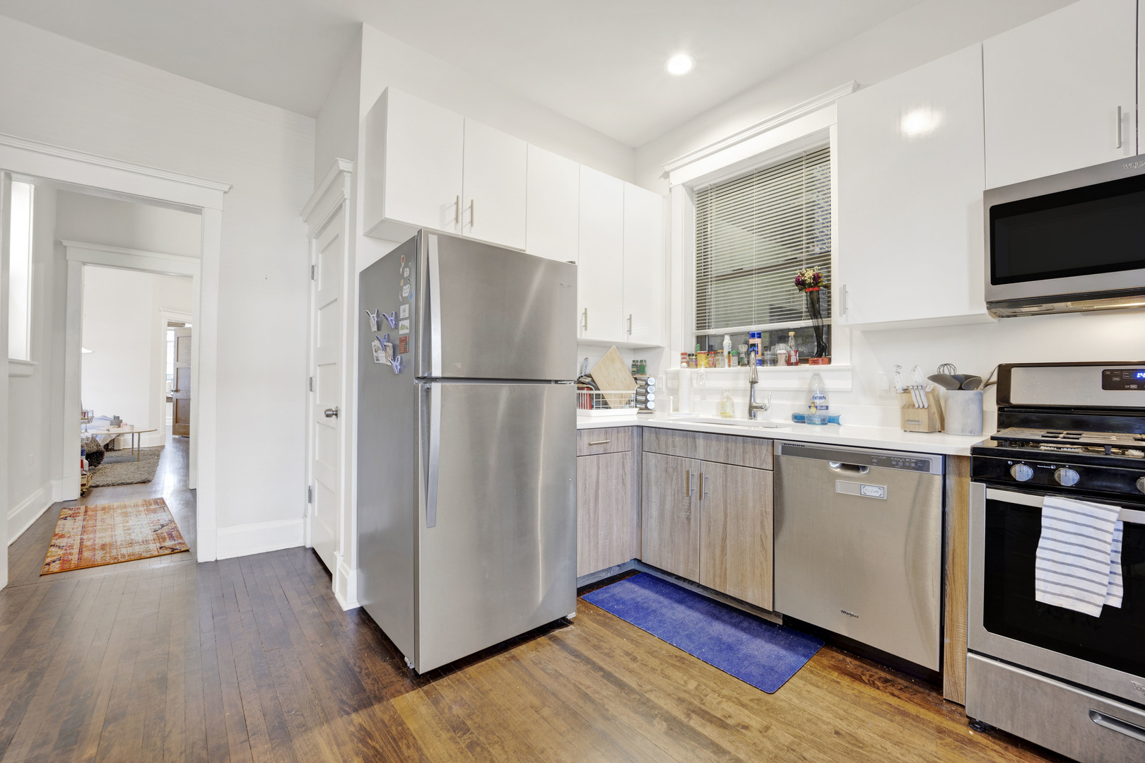 3934 North Sheridan Road, Unit 3 Chicago, IL 60613 - Photo 9 of 12 a kitchen with a refrigerator cabinets and wooden floor
