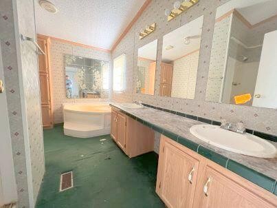 181 Wild Oak Road Southeast Cleveland, TN 37323 - Photo 7 of 12 a bathroom with a granite countertop sink and mirror with bathtub