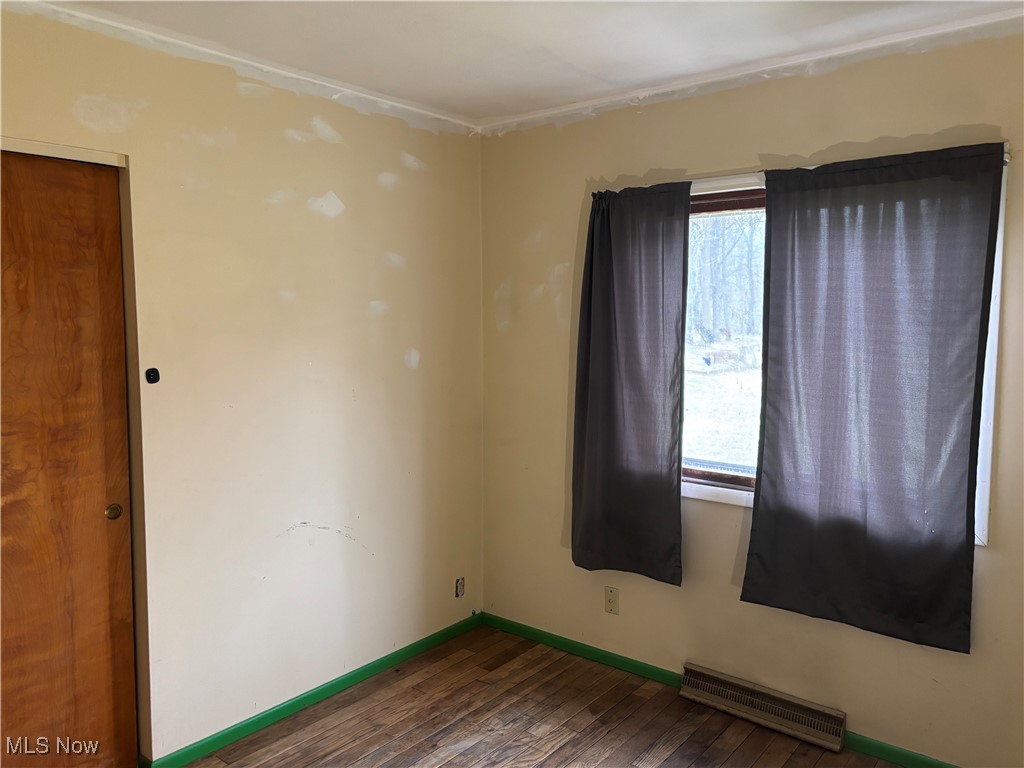 115 Lee Road Painesville, OH 44077 - Photo 9 of 19 Bedroom with wood-type flooring, plenty of natural light, baseboards, and visible vents