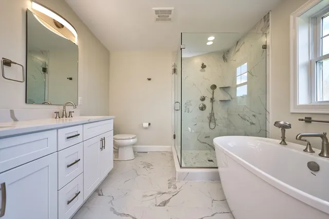 a bathroom with a double vanity sink mirror double and bathtub