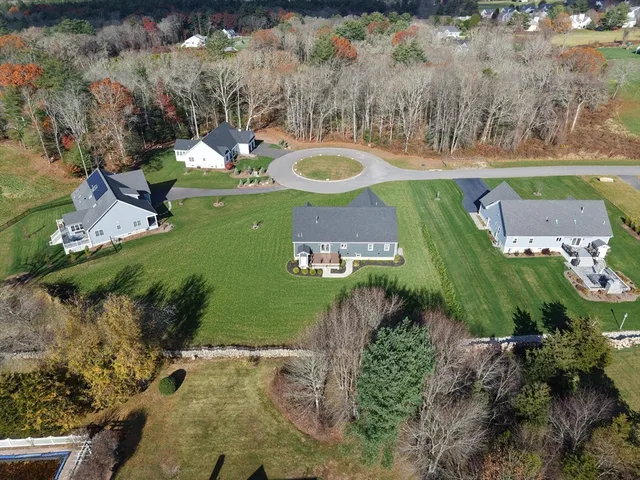 an aerial view of a house with yard swimming pool and outdoor seating