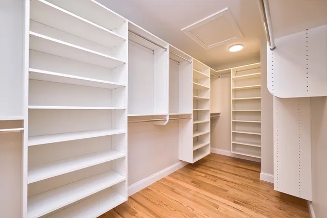 a view of walk in closet with empty racks