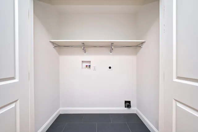 a view of walk in closet with clothes