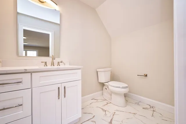 a bathroom with a sink toilet and vanity