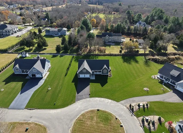an aerial view of a house with a swimming pool and outdoor seating