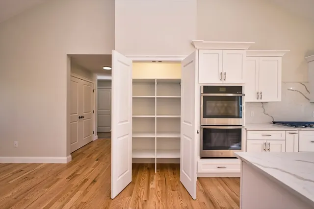 a kitchen with stainless steel appliances a stove and cabinets
