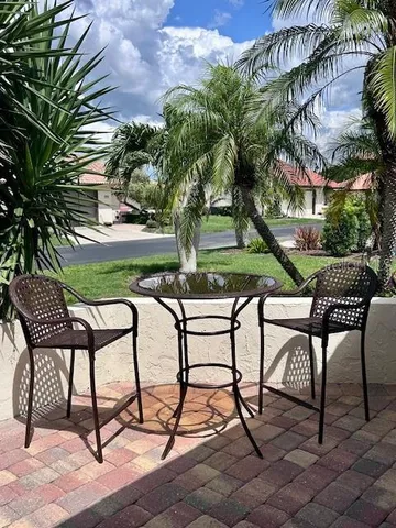 a view of a chairs and table in backyard