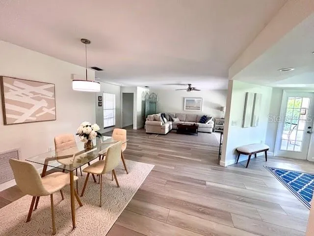 a living room with furniture a table and chairs