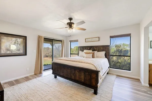 a bedroom with a large bed and a chandelier